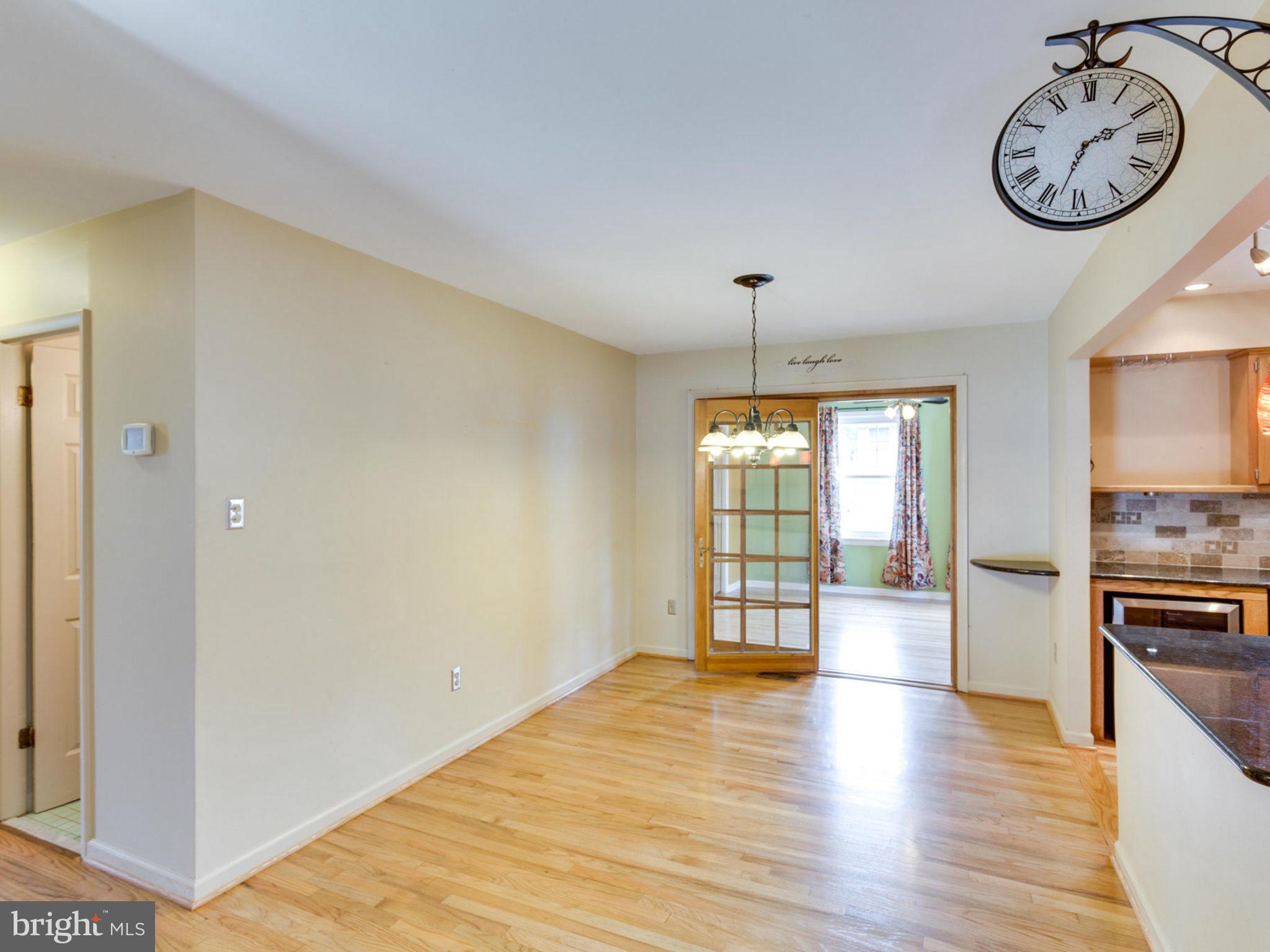 415 Rockway Road Catonsville, MD 21228 - Photo 5 of 30 a view of an empty room with window and wooden floor