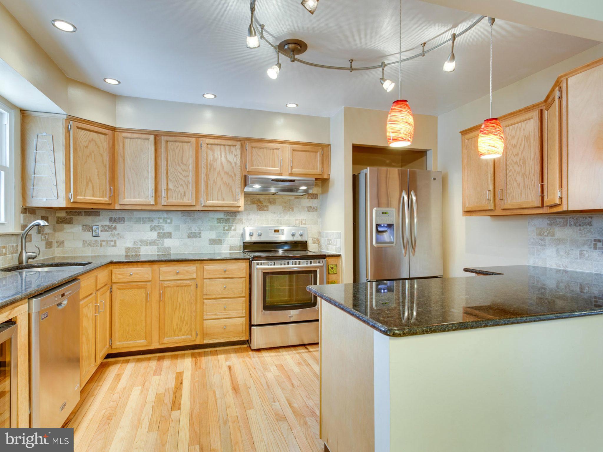 415 Rockway Road Catonsville, MD 21228 - Photo 7 of 30 a large kitchen with stainless steel appliances granite countertop a sink a stove a refrigerator and a cabinets