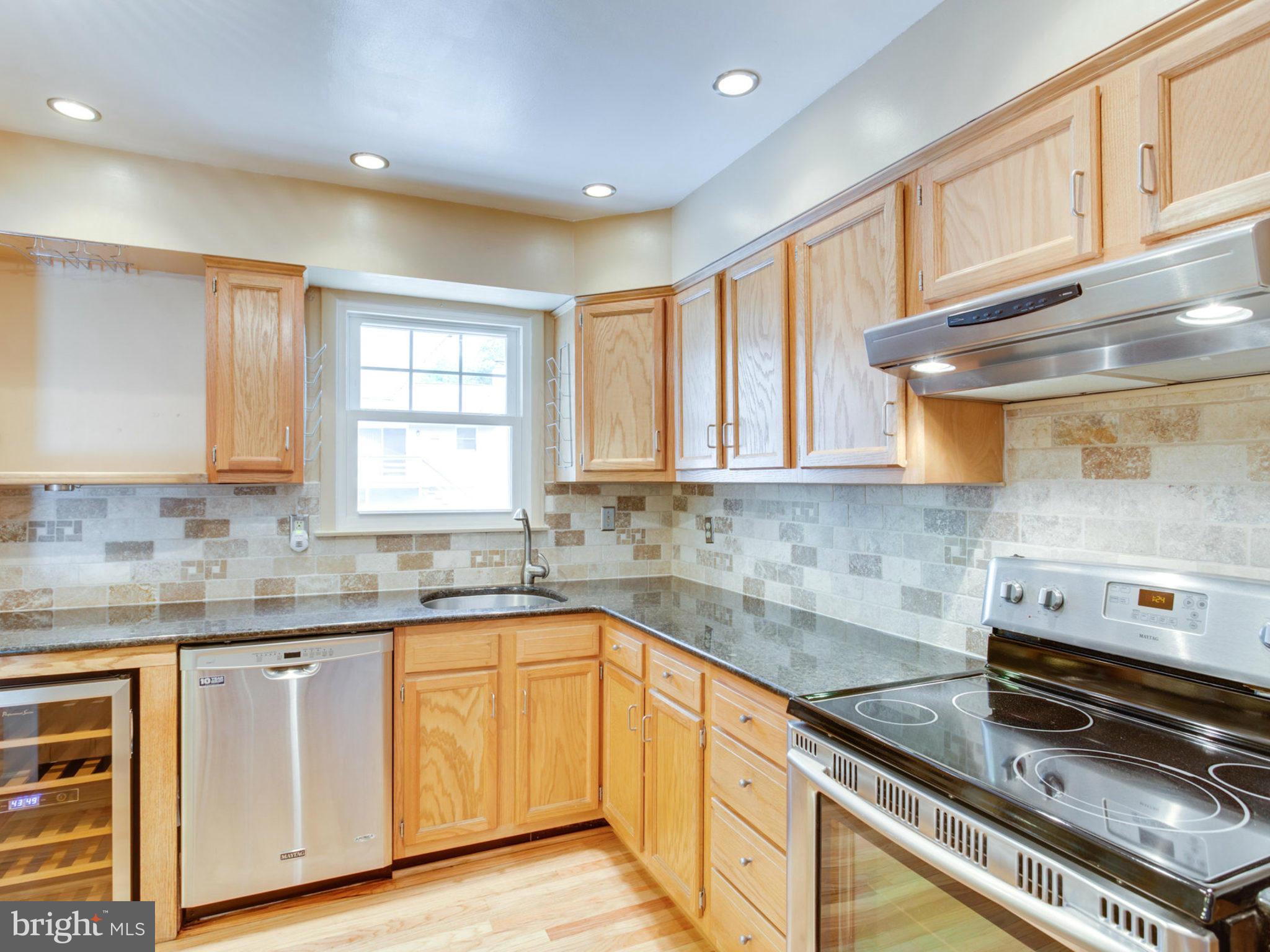 415 Rockway Road Catonsville, MD 21228 - Photo 10 of 30 a kitchen with granite countertop a sink stove and cabinets