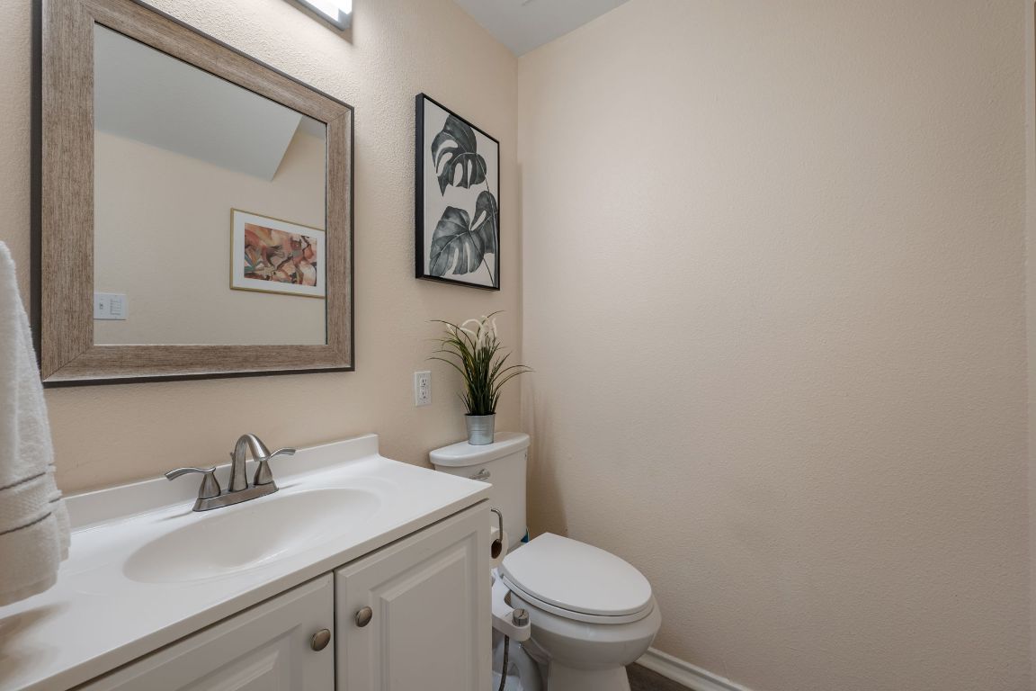 1607 Azalea Drive Cedar Park, TX 78613 - Photo 14 of 40 a bathroom with a toilet sink and mirror