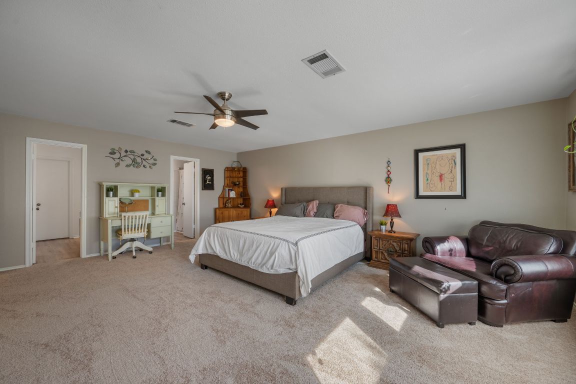 1607 Azalea Drive Cedar Park, TX 78613 - Photo 17 of 40 a spacious bedroom with a bed and a couch