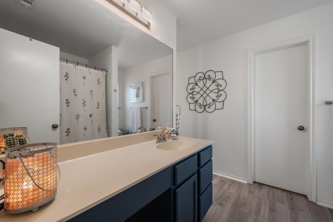 1607 Azalea Drive Cedar Park, TX 78613 - Photo 19 of 40 a bathroom with a sink a mirror and a bathtub
