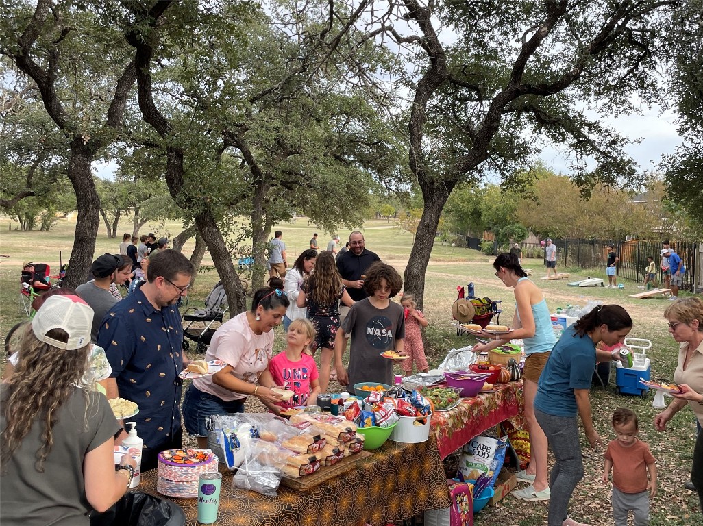 1607 Azalea Drive Cedar Park, TX 78613 - Photo 38 of 40 a group of people standing around a fruit stand