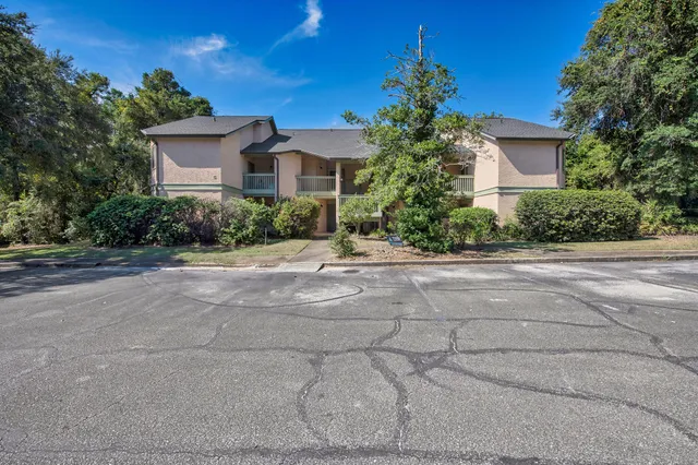 a front view of a house with a yard and a garage