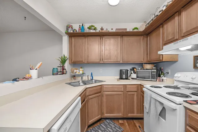 a kitchen with a sink a stove and cabinets