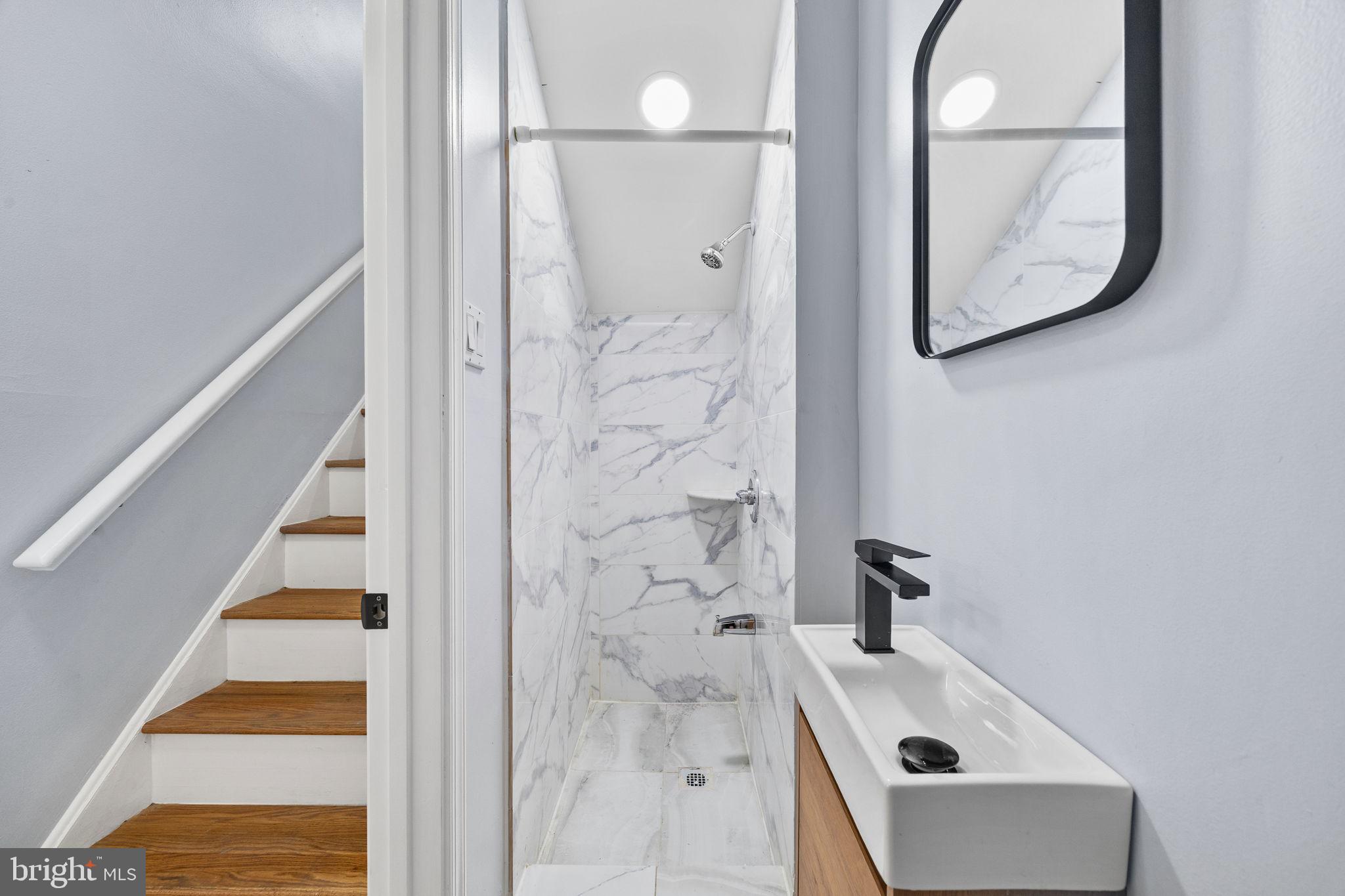1130 Lombard Street Philadelphia, PA 19147 - Photo 38 of 45 a bathroom with a sink and a mirror
