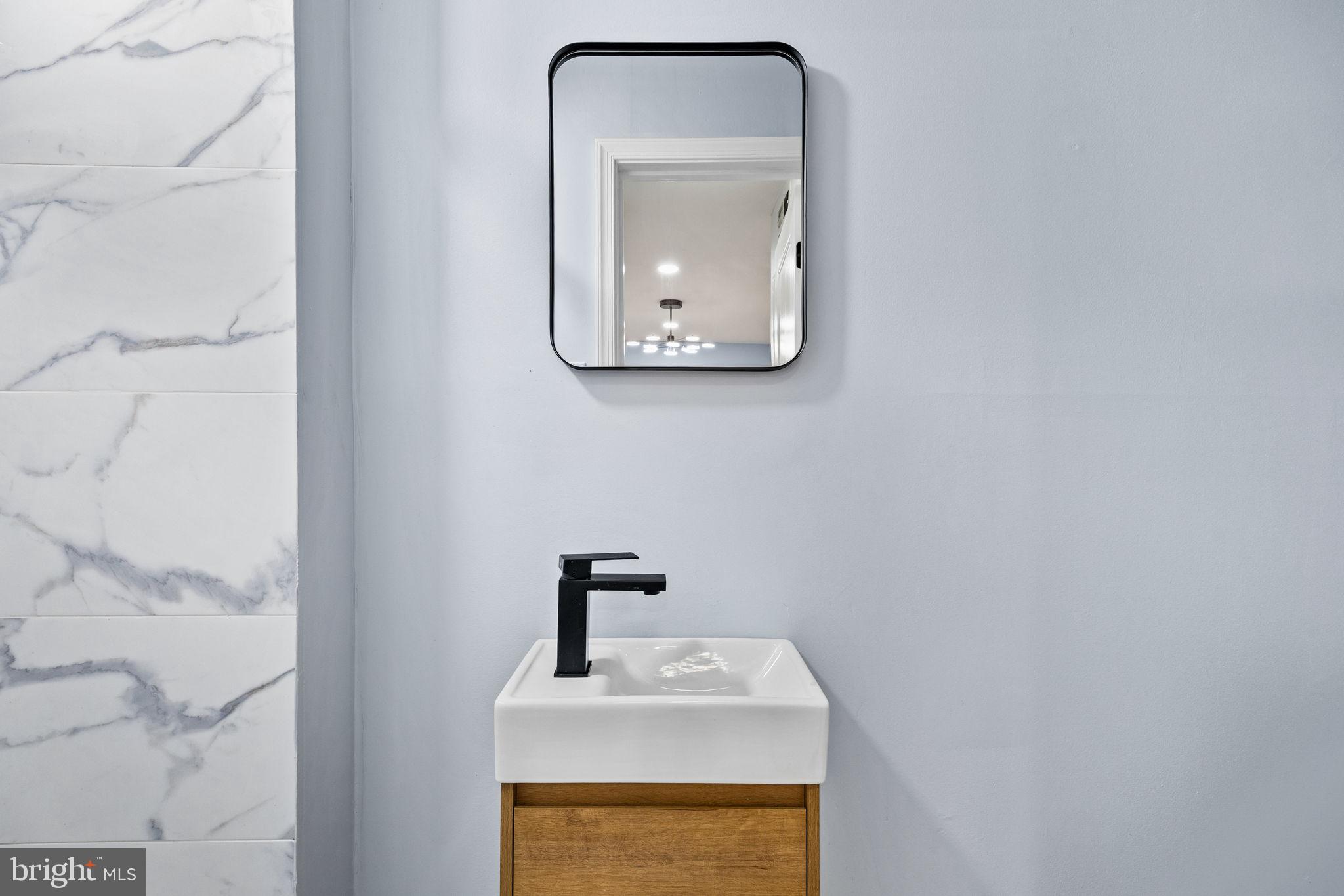 1130 Lombard Street Philadelphia, PA 19147 - Photo 39 of 45 a bathroom with a sink and a mirror