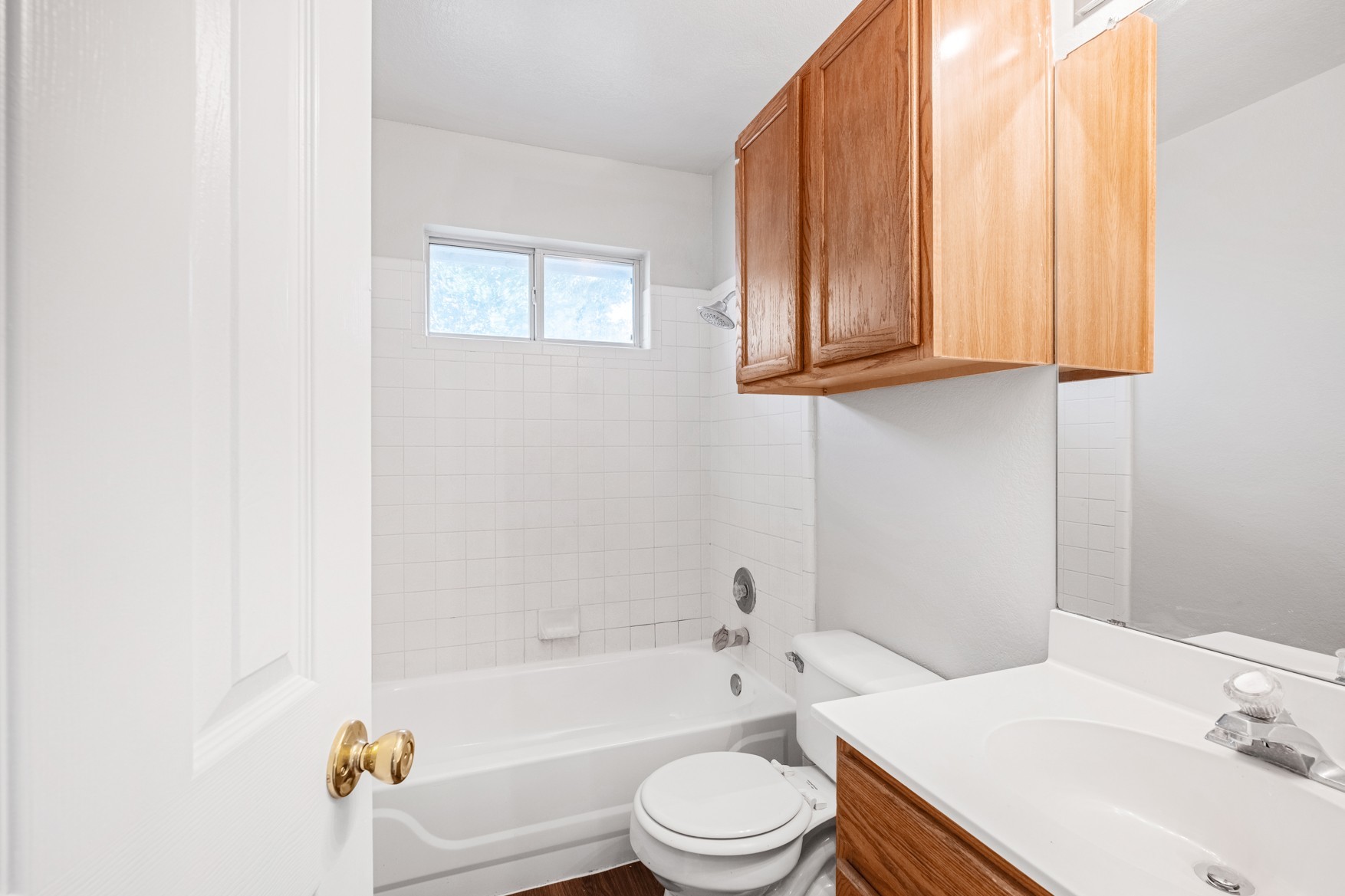3709 Crownover Street Austin, TX 78725 - Photo 17 of 26 Bathroom featuring a window, white tiled walls, a bathtub with shower fixture, and a vanity with a sink and a mirror