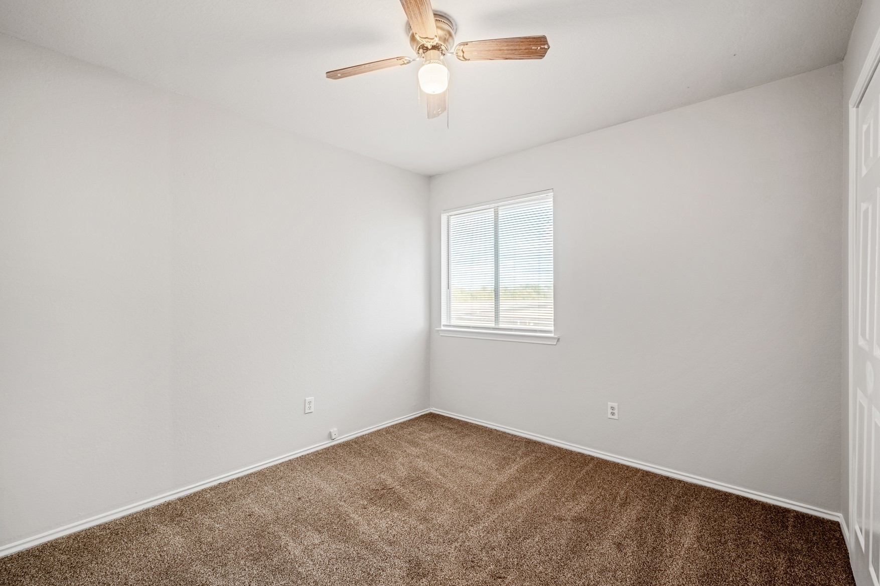 3709 Crownover Street Austin, TX 78725 - Photo 19 of 26 This room features neutral-toned walls, brown carpet, and a window with blinds providing natural light