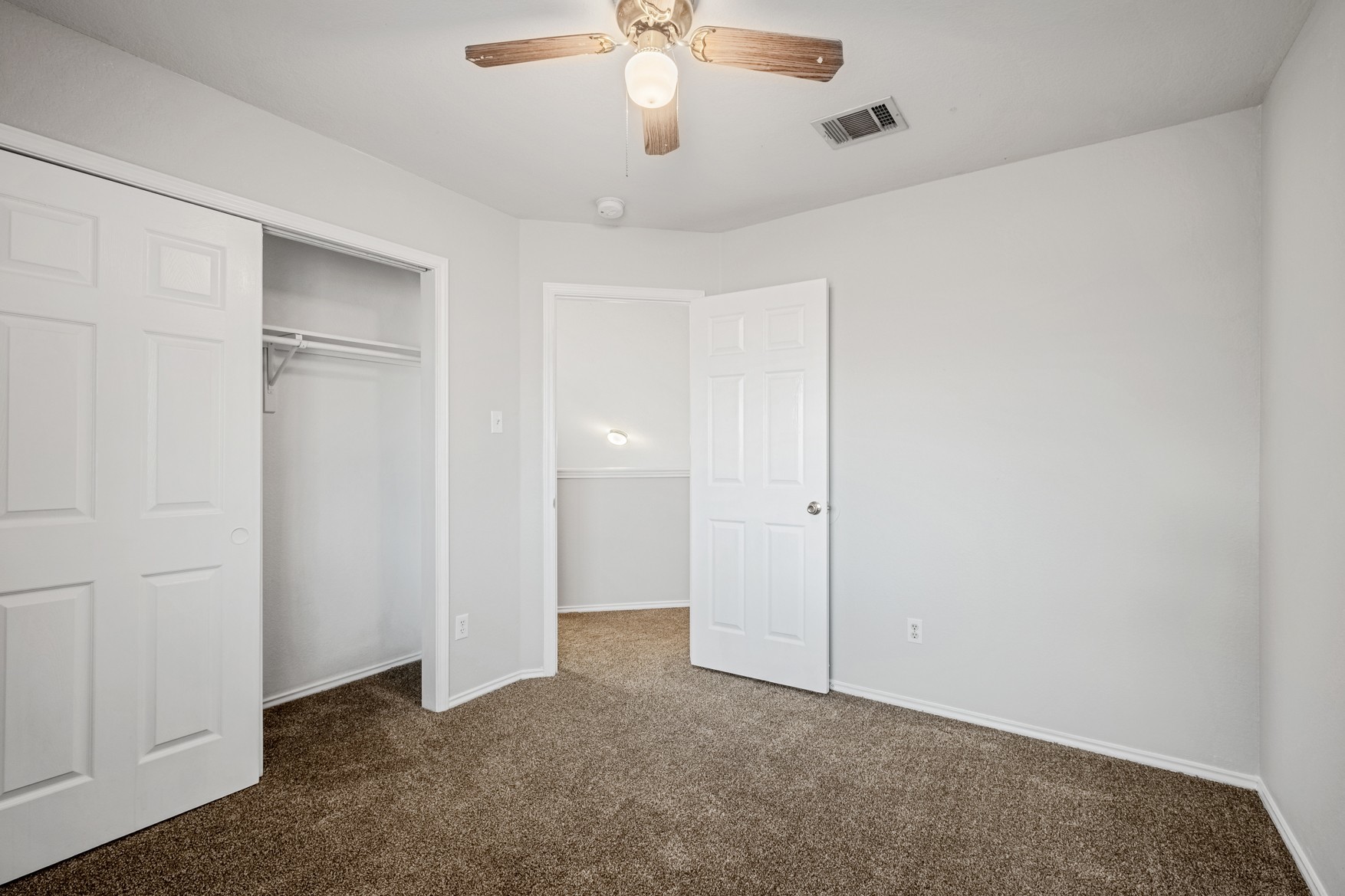 3709 Crownover Street Austin, TX 78725 - Photo 20 of 26 Bedroom featuring light grey walls, brown carpet, and a ceiling fan with light fixture