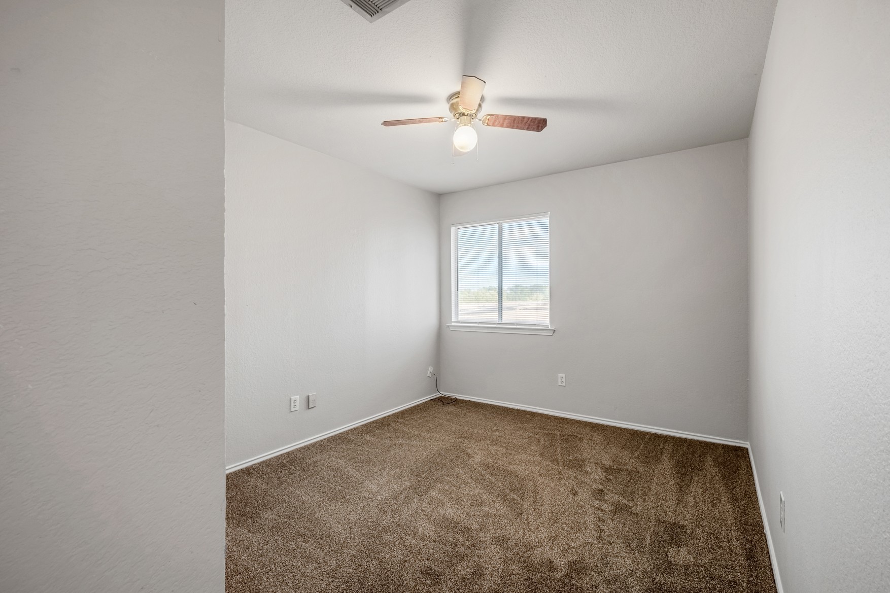 3709 Crownover Street Austin, TX 78725 - Photo 21 of 26 This room features light-colored walls and brown carpeting, creating a neutral palette
