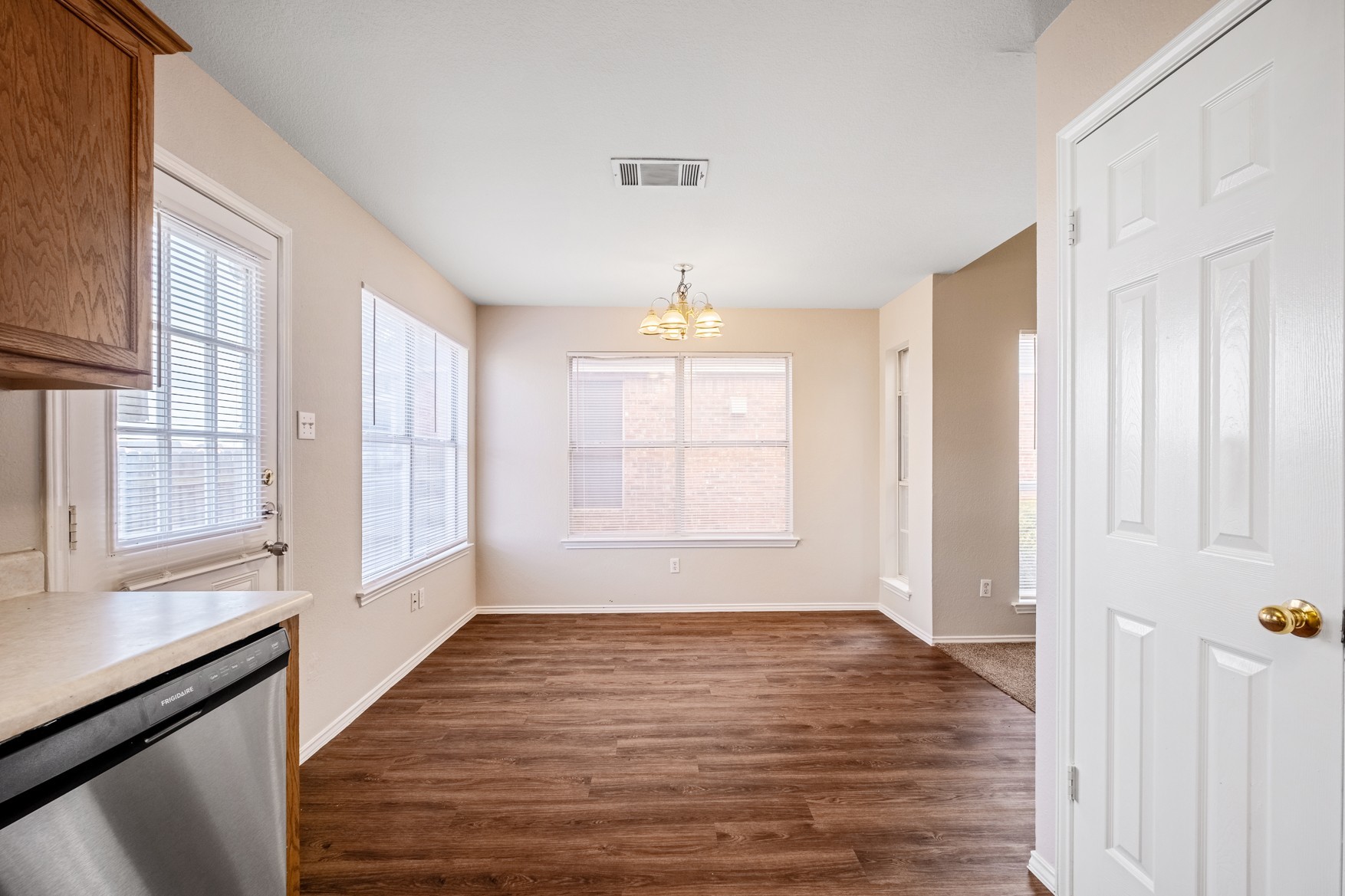 3709 Crownover Street Austin, TX 78725 - Photo 9 of 26 The property features hard surface flooring, light-colored walls, and a chandelier-style light fixture
