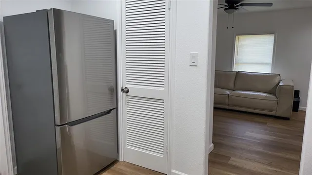 a kitchen with a refrigerator and a sink