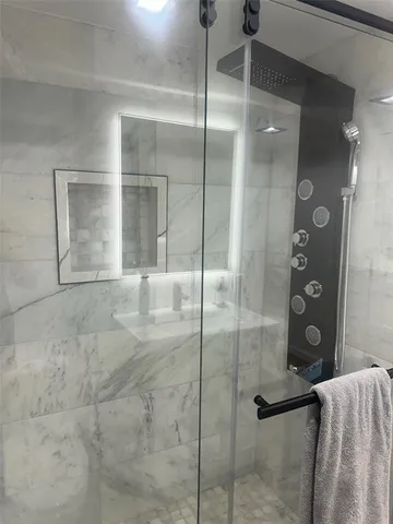 a bathroom with a glass shower door