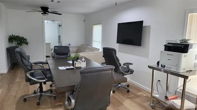 a view of a workspace with furniture and a flat screen tv