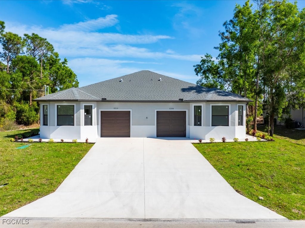 a front view of house with a garden