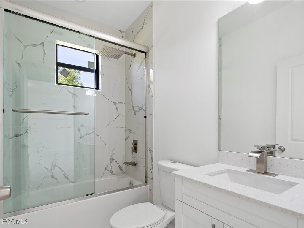 5210 28th Street Southwest Lehigh Acres, FL 33973 - Photo 10 of 12 a bathroom with a sink toilet and shower