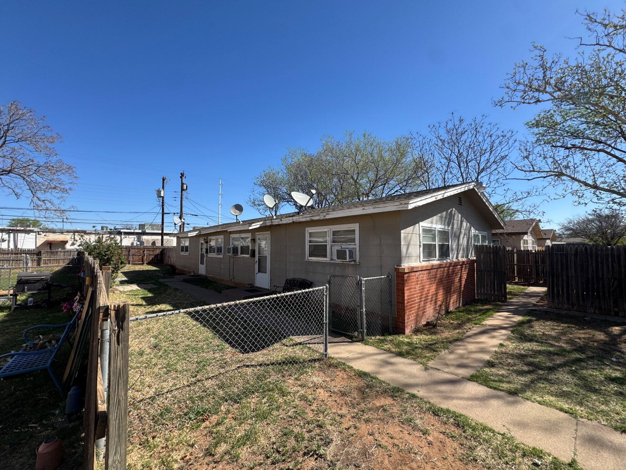 a view of a house with wooden fence
