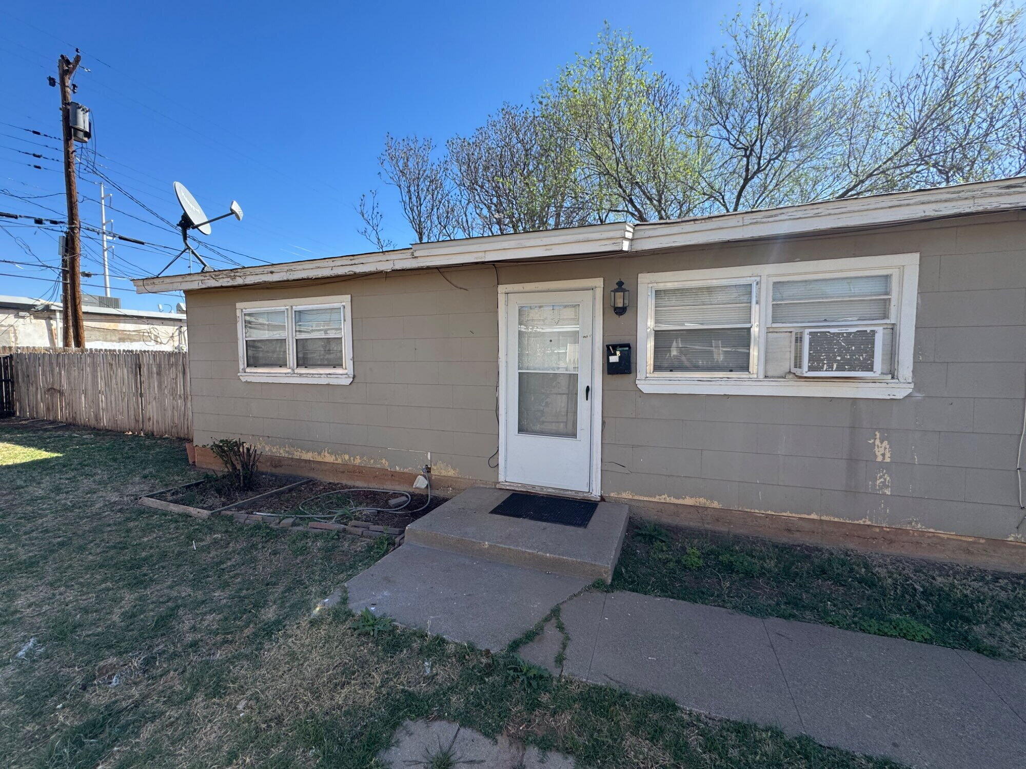 2208 35th Street, Unit B Lubbock, TX 79412 - Photo 2 of 9 a backyard of a house with seating space
