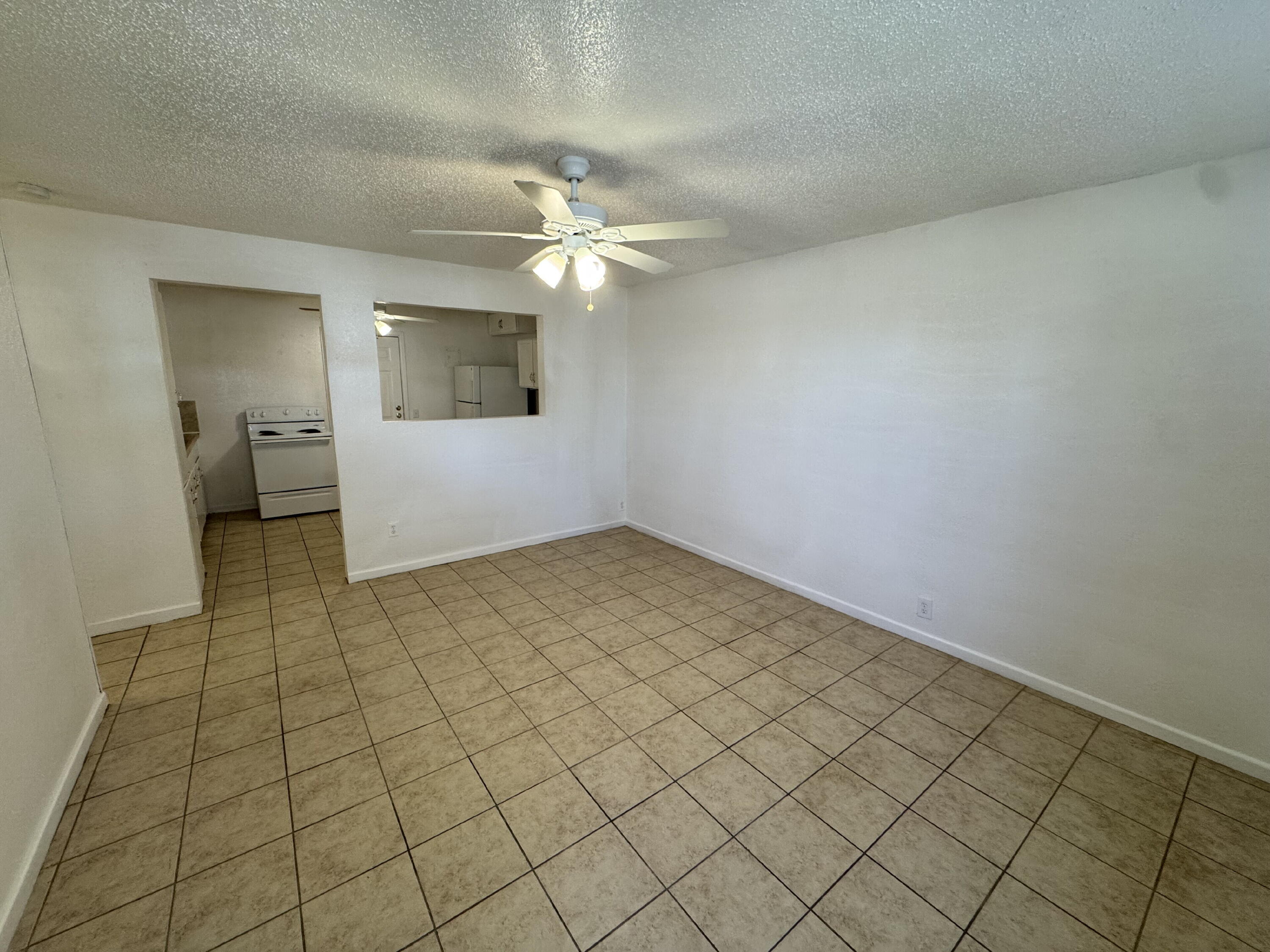 2208 35th Street, Unit B Lubbock, TX 79412 - Photo 3 of 9 a view of a livingroom with a chandelier fan and furniture