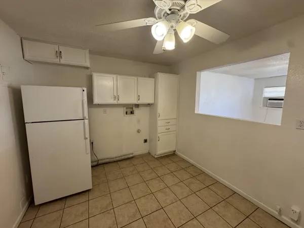 a view of a kitchen with a refrigerator and a microwave