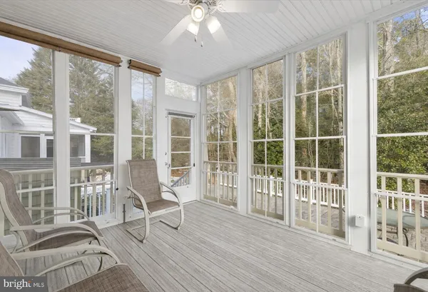 a view of a room with wooden floor and windows