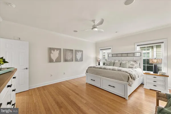 a spacious bedroom with a bed and a large window