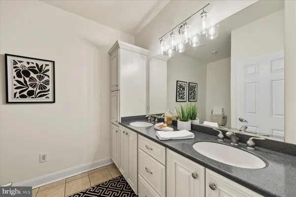 a bathroom with a sink a large mirror and a shower