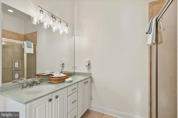 a bathroom with a sink a mirror and a shower