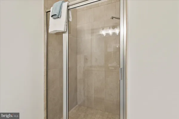 a bathroom with a glass shower door