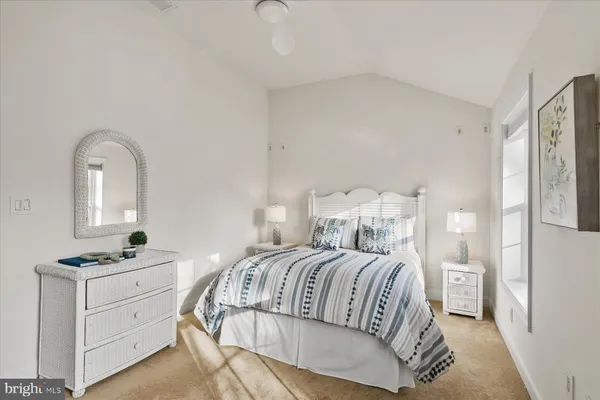 a bedroom with a bed and a night stand