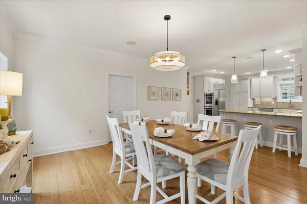 a view of a dining room with furniture wooden floor and chandelier