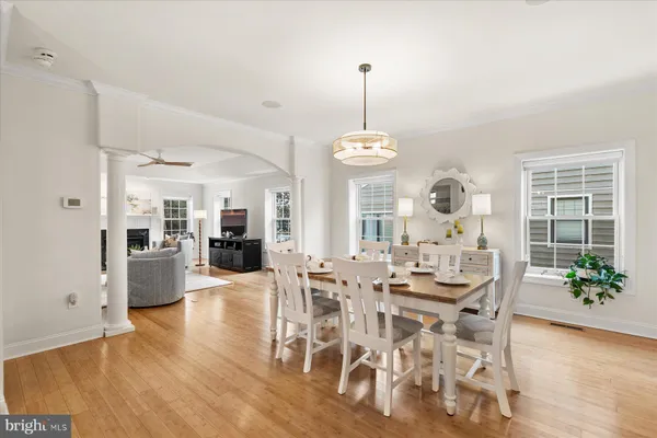 a view of a dining room with furniture wooden floor and chandelier
