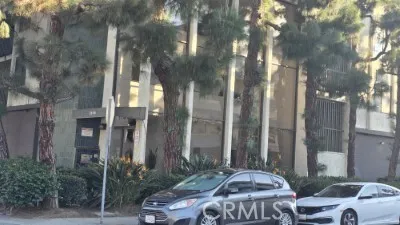 a couple of cars parked in front of building