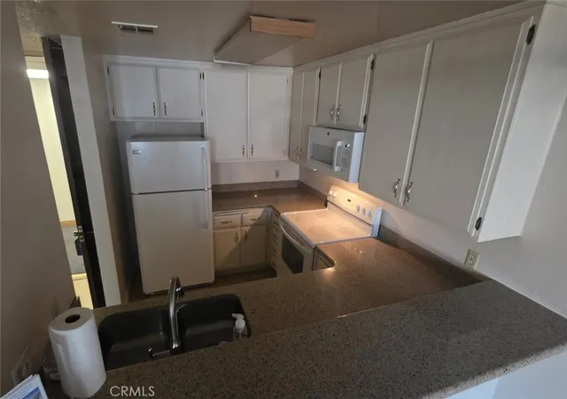 a kitchen with refrigerator and window