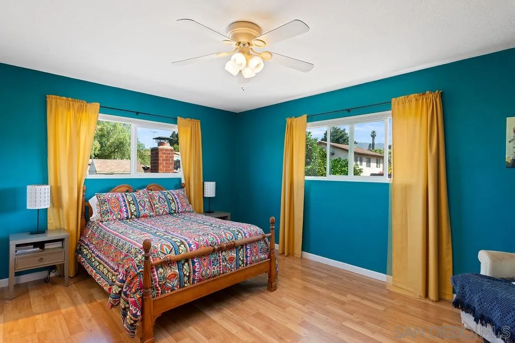 14134 Lyons Valley Road Jamul, CA 91935 - Photo 12 of 25 a bedroom with a bed and a chandelier