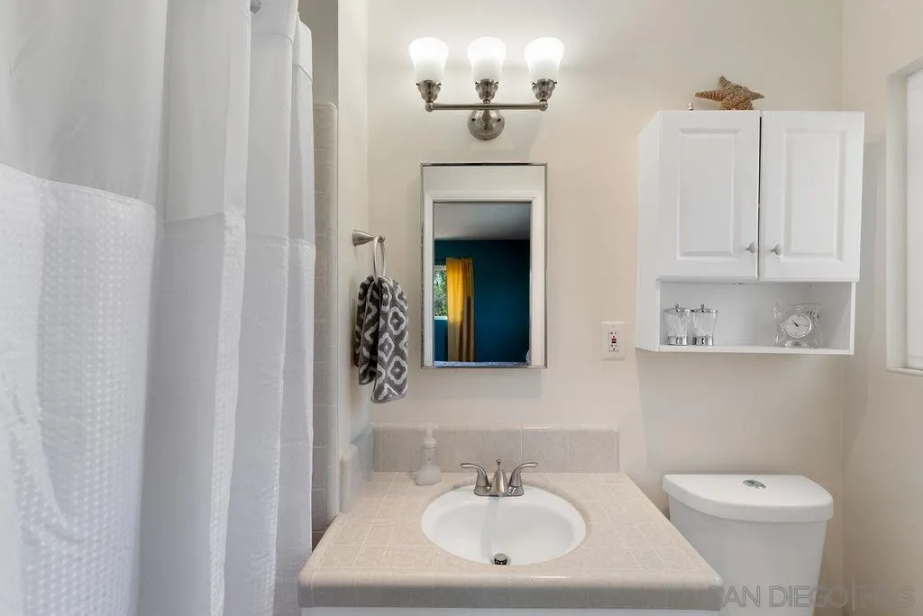 14134 Lyons Valley Road Jamul, CA 91935 - Photo 14 of 25 a bathroom with a toilet sink and mirror