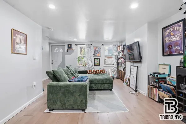 a living room with furniture and a flat screen tv