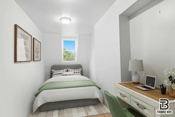 a bedroom with a bed and a window