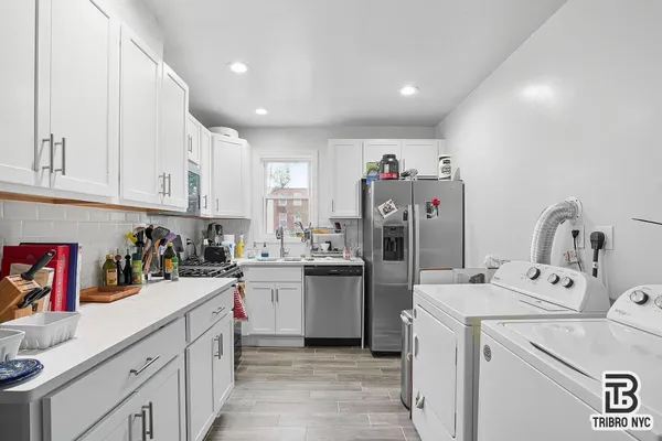 a kitchen with a refrigerator and sink