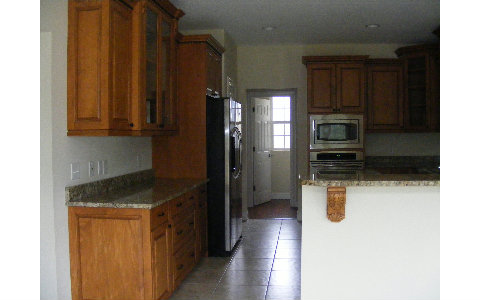 96103 Captains Pointe Road Yulee, FL 32097 - Photo 5 of 14 a kitchen with stainless steel appliances granite countertop a refrigerator and a sink