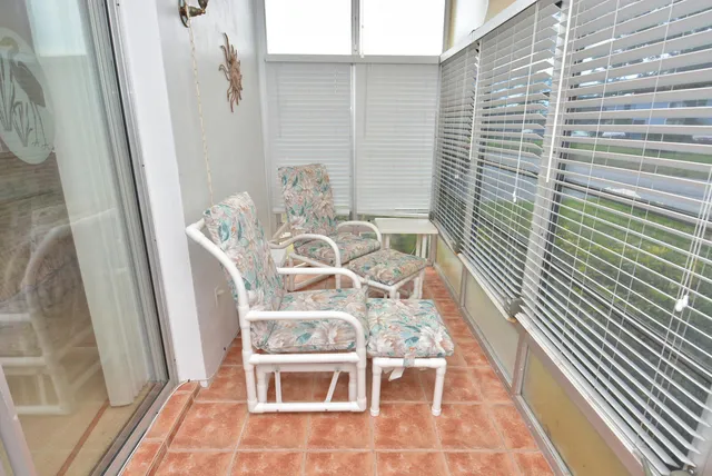 a view of a balcony with table and chairs