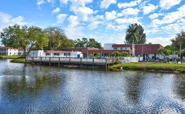 a view of swimming pool with outdoor seating and lake view
