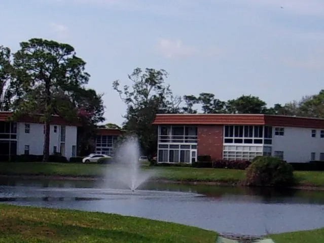 a view of house with yard and green space