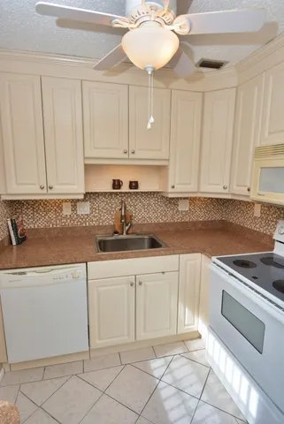 a kitchen with cabinets appliances and a counter top space