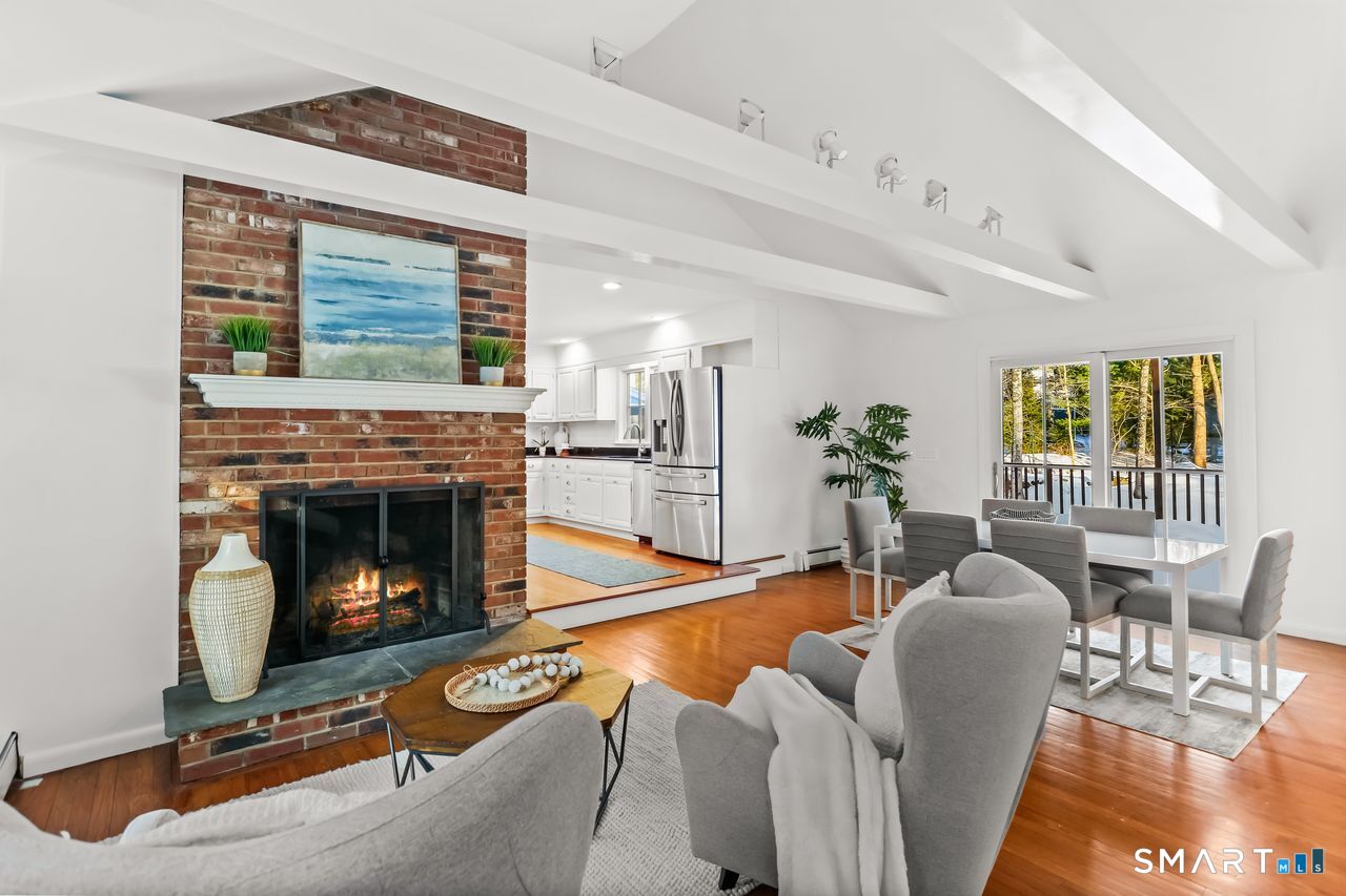 103 Davis Hill Road Weston, CT 06883 - Photo 12 of 37 a living room with furniture a flat screen tv and a fireplace