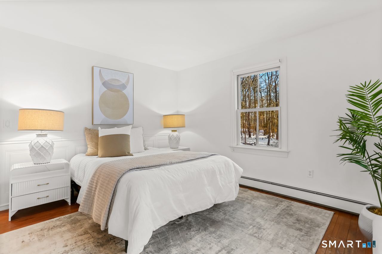 103 Davis Hill Road Weston, CT 06883 - Photo 15 of 37 a bedroom with a bed and a window