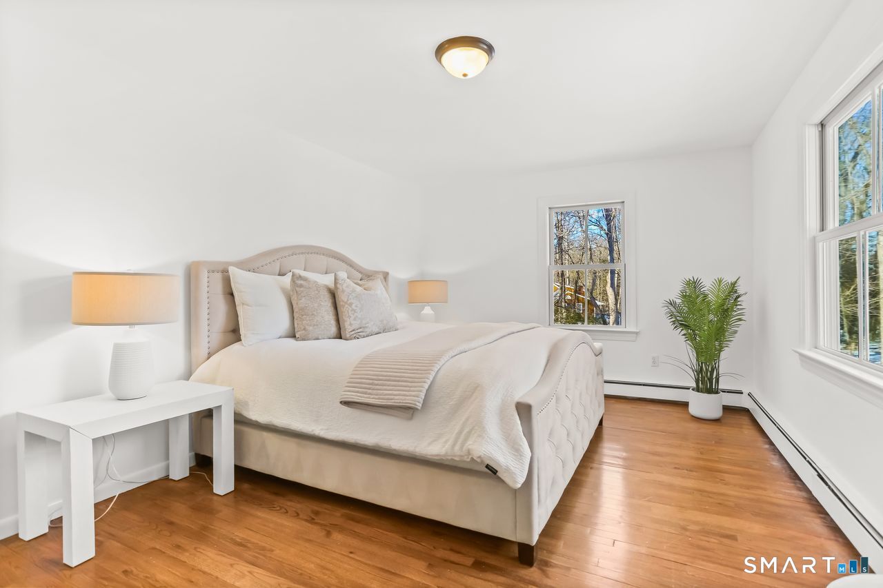 103 Davis Hill Road Weston, CT 06883 - Photo 20 of 37 a spacious bedroom with a bed and a window