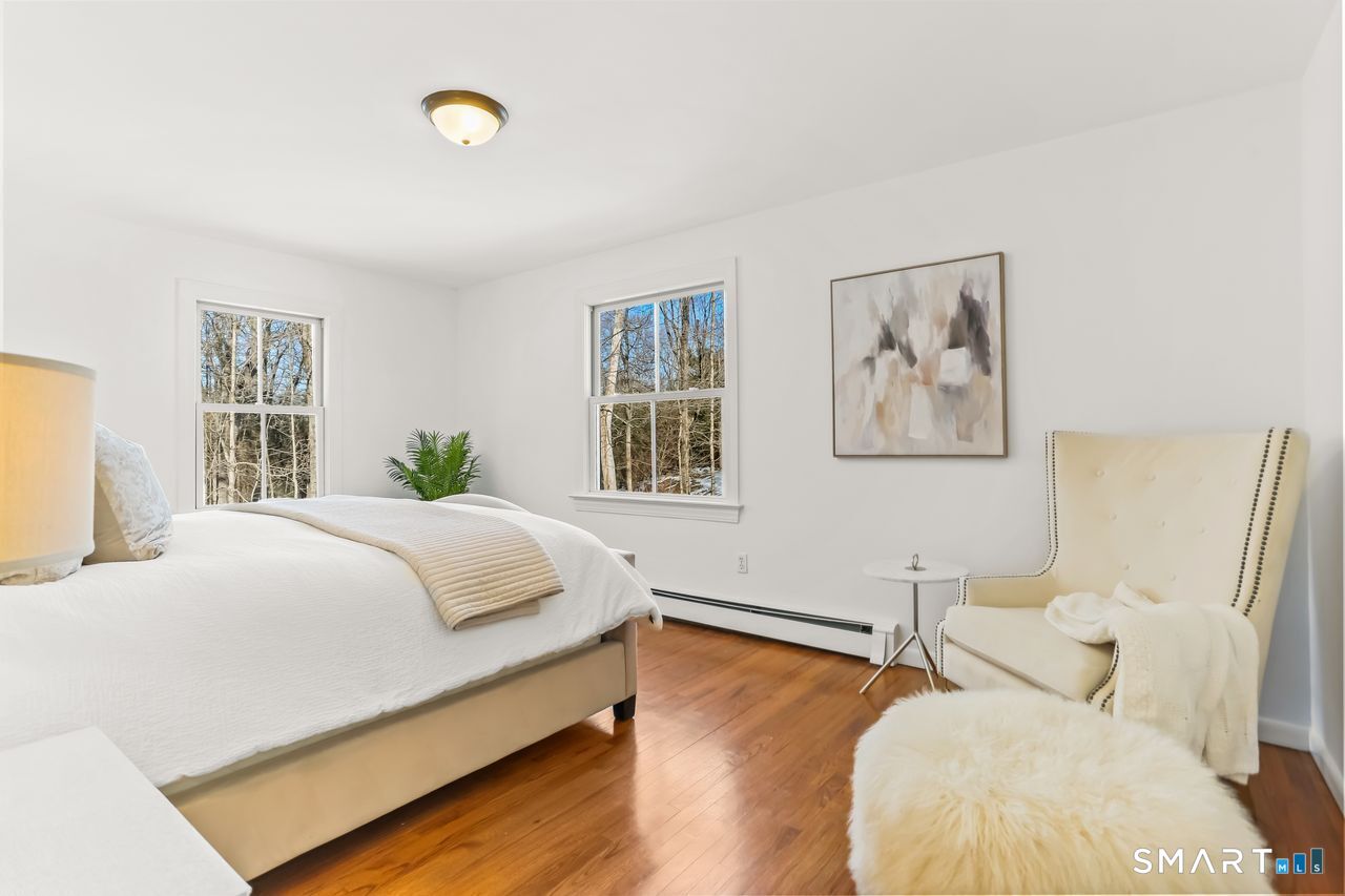 103 Davis Hill Road Weston, CT 06883 - Photo 21 of 37 a bedroom with a bed and wooden floor