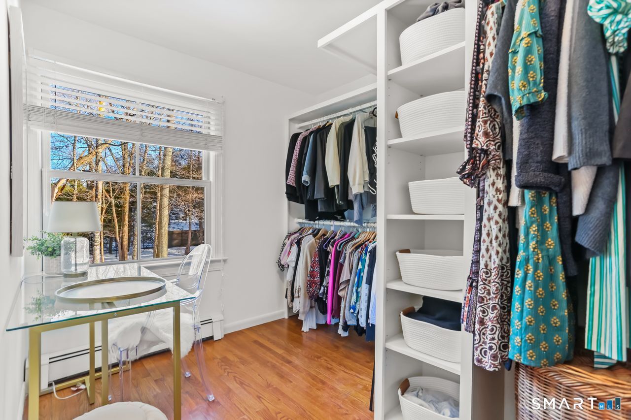 103 Davis Hill Road Weston, CT 06883 - Photo 22 of 37 a view of walk in closet with clothes and shoes